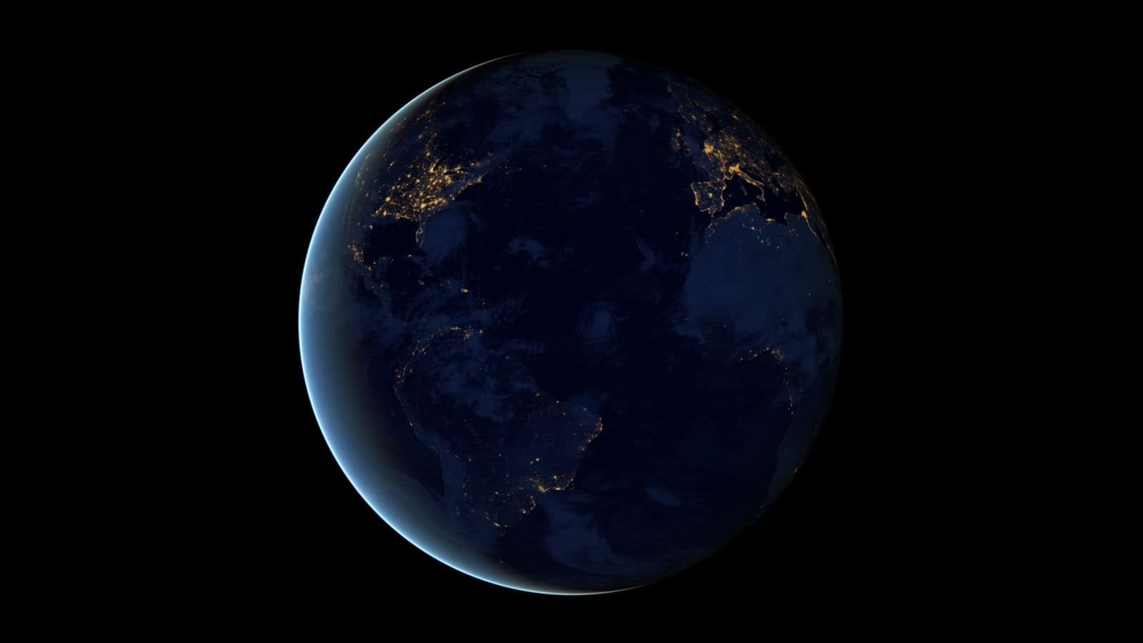 Earth at night from space, city lights visible across the continents